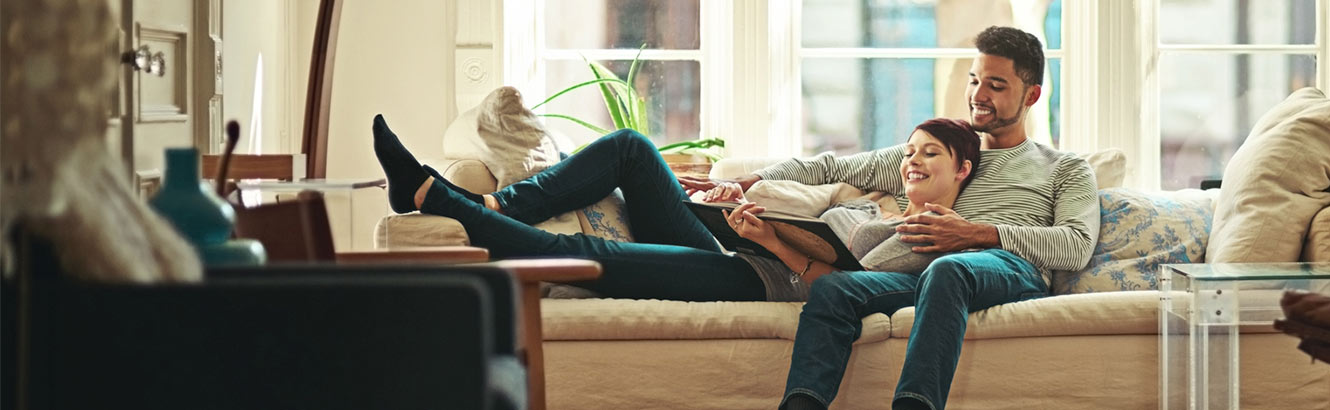 couple enjoying a book in their new home.